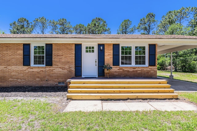 150 Willetts Dr, Southport, NC 28461 - view of front of house featuring brick siding, an attached carport, and crawl space
