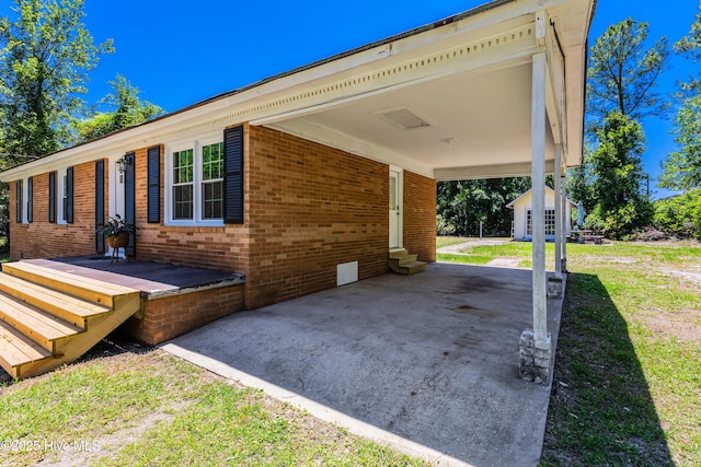 150 Willetts Dr, Southport, NC 28461 - view of side of property with brick siding, a carport, and entry steps