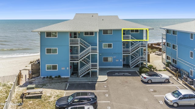 1437 Fort Fisher Blvd S Unit D3, Kure Beach, NC 28449 - view of property with uncovered parking, view of water and beach, and stairs