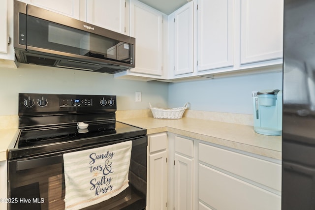 1437 Fort Fisher Blvd S Unit D3, Kure Beach, NC 28449 - kitchen with black appliances, light countertops, and white cabinetry
