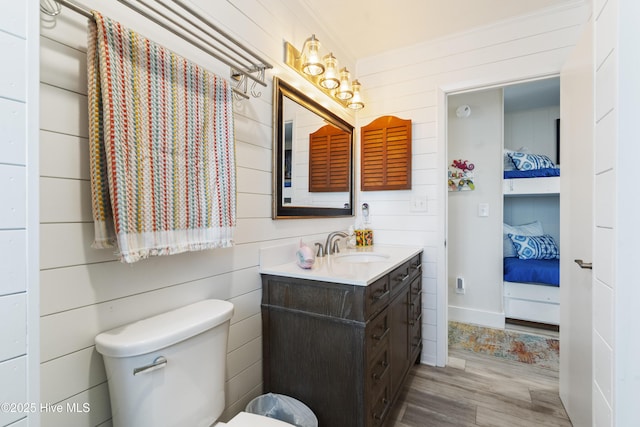 1437 Fort Fisher Blvd S Unit D3, Kure Beach, NC 28449 - bathroom with vanity, wood finished floors, toilet, crown molding, and wooden walls