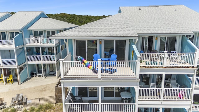 1437 Fort Fisher Blvd S Unit D3, Kure Beach, NC 28449 - rear view of house featuring roof with shingles and a patio area