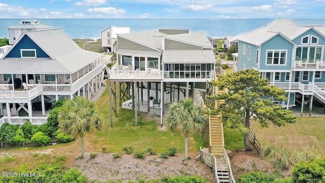 6008 W Beach Dr, Oak Island, NC 28465 - back of property featuring a water view, a sunroom, and stairway