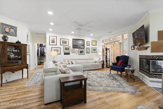 106 N Shore Dr, Sneads Ferry, NC 28460 - living room featuring a ceiling fan, recessed lighting, plenty of natural light, crown molding, and wood finished floors