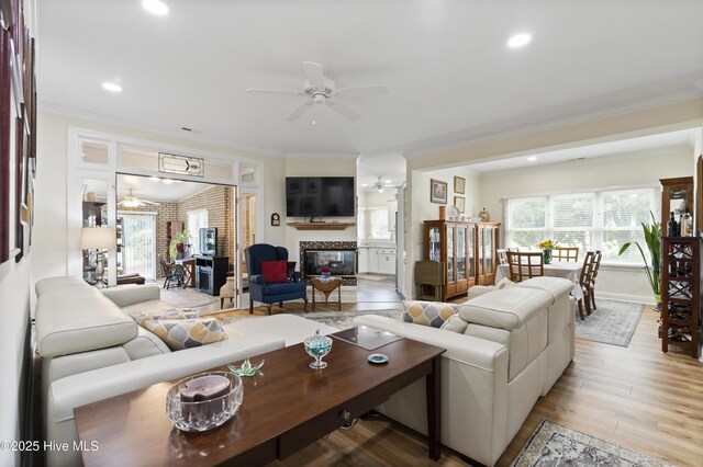 106 N Shore Dr, Sneads Ferry, NC 28460 - living room featuring ornamental molding, a fireplace, a ceiling fan, recessed lighting, and light wood-type flooring