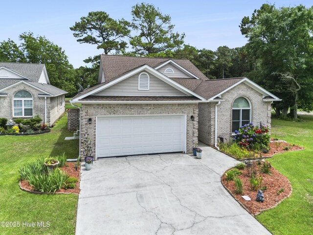106 N Shore Dr, Sneads Ferry, NC 28460 - view of front of property featuring concrete driveway, brick siding, a front lawn, and a garage