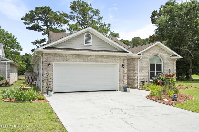 106 N Shore Dr, Sneads Ferry, NC 28460 - ranch-style home with an attached garage, concrete driveway, brick siding, a front yard, and roof with shingles