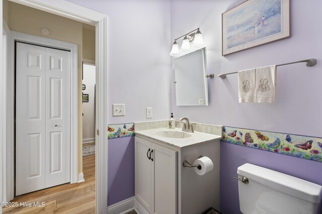 106 N Shore Dr, Sneads Ferry, NC 28460 - bathroom featuring wood finished floors, vanity, toilet, and baseboards