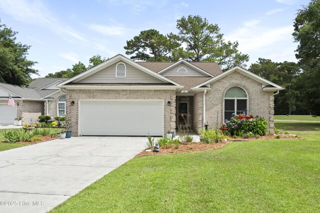 106 N Shore Dr, Sneads Ferry, NC 28460 - single story home with concrete driveway, a garage, a front lawn, and brick siding