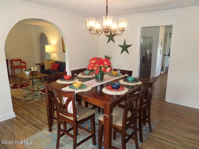 108 Swan Point Rd, Bayboro, NC 28515 - dining area with arched walkways, wood finished floors, crown molding, a chandelier, and baseboards