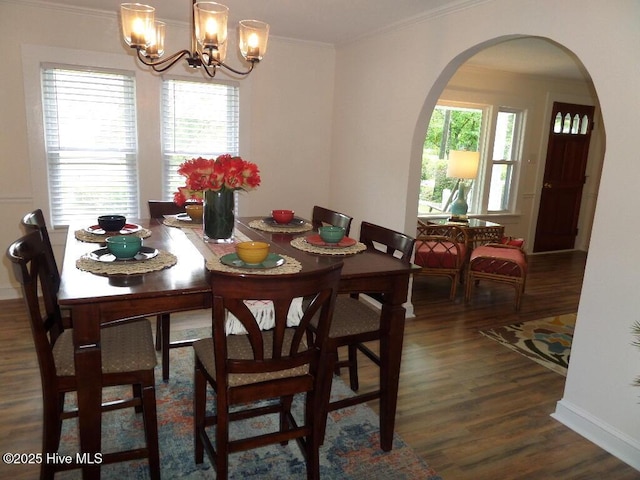 108 Swan Point Rd, Bayboro, NC 28515 - dining space with arched walkways, wood finished floors, ornamental molding, a chandelier, and baseboards