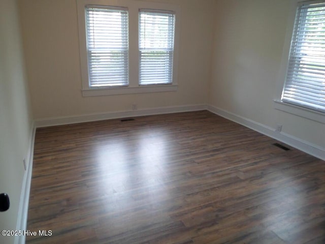 108 Swan Point Rd, Bayboro, NC 28515 - empty room featuring baseboards and dark wood finished floors