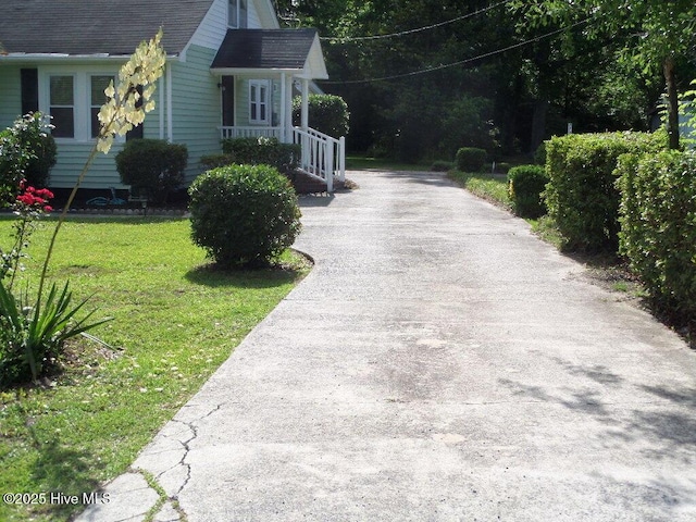 108 Swan Point Rd, Bayboro, NC 28515 - view of property exterior with asphalt driveway, a yard, and a shingled roof