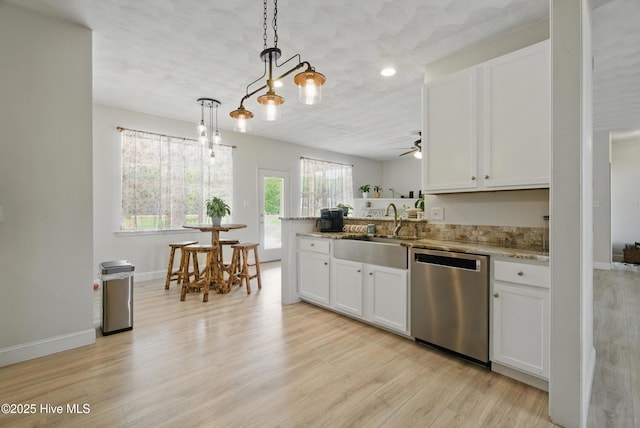 118 Stedman Ln E, Elizabeth City, NC 27909 - kitchen with stainless steel dishwasher, a sink, light wood-style floors, white cabinets, and recessed lighting
