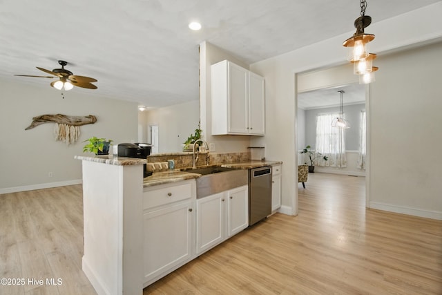 118 Stedman Ln E, Elizabeth City, NC 27909 - kitchen with stainless steel dishwasher, white cabinetry, light wood-style flooring, light stone counters, and recessed lighting