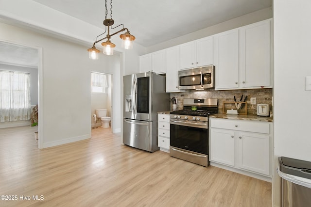 118 Stedman Ln E, Elizabeth City, NC 27909 - kitchen featuring appliances with stainless steel finishes, backsplash, light wood-style flooring, and white cabinets