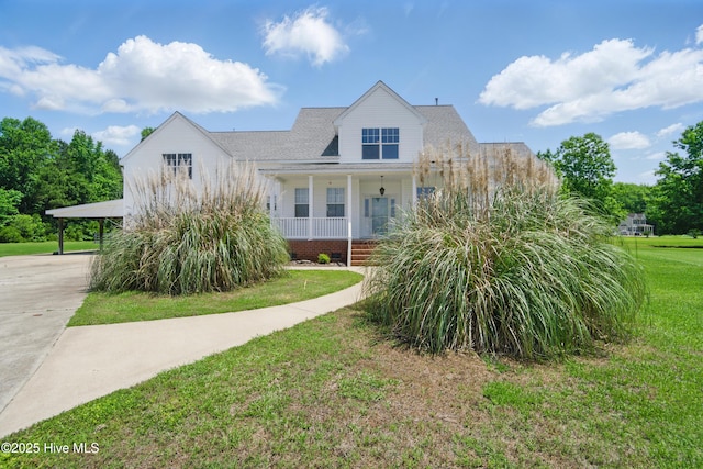 118 Stedman Ln E, Elizabeth City, NC 27909 - view of front of home with covered porch, concrete driveway, a front yard, and a carport