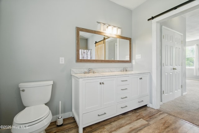 118 Stedman Ln E, Elizabeth City, NC 27909 - full bath with double vanity, wood finished floors, toilet, and baseboards