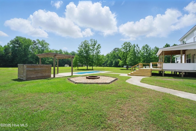 118 Stedman Ln E, Elizabeth City, NC 27909 - view of grassy yard with a fire pit, a pergola, and a wooden deck