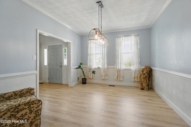 118 Stedman Ln E, Elizabeth City, NC 27909 - unfurnished dining area featuring light wood finished floors, crown molding, and wainscoting