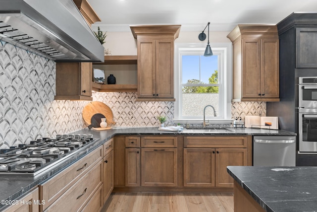 412 Keziah St, Oak Island, NC 28465 - kitchen featuring stainless steel appliances, a sink, wall chimney exhaust hood, open shelves, and dark stone counters