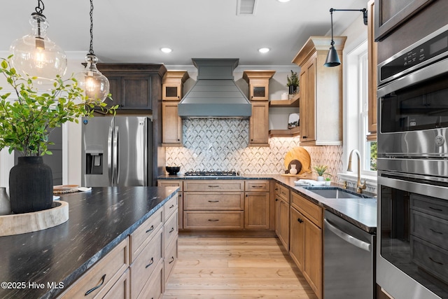 412 Keziah St, Oak Island, NC 28465 - kitchen with appliances with stainless steel finishes, premium range hood, a sink, light wood finished floors, and open shelves