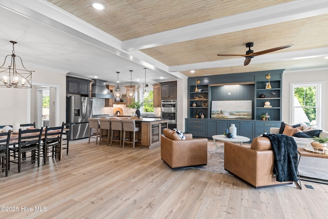 412 Keziah St, Oak Island, NC 28465 - living room featuring plenty of natural light, light wood finished floors, crown molding, recessed lighting, and wooden ceiling with exposed beams