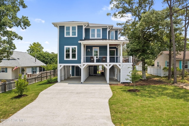412 Keziah St, Oak Island, NC 28465 - coastal inspired home featuring a carport, stairs, driveway, a porch, and metal roof