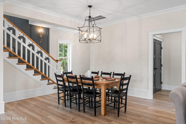 412 Keziah St, Oak Island, NC 28465 - dining space featuring wood finished floors, stairs, a chandelier, ornamental molding, and baseboards