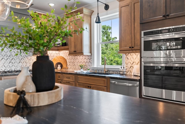 412 Keziah St, Oak Island, NC 28465 - kitchen with appliances with stainless steel finishes, a sink, tasteful backsplash, and dark countertops