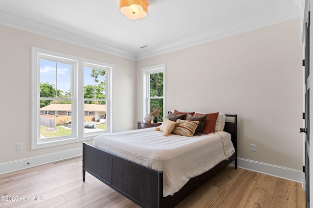 412 Keziah St, Oak Island, NC 28465 - bedroom with ornamental molding, light wood-style flooring, and baseboards