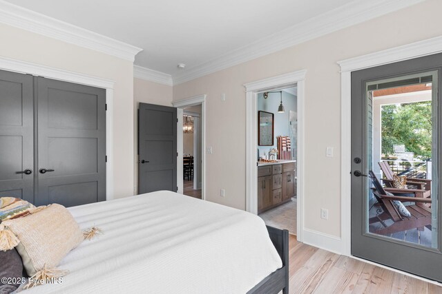 412 Keziah St, Oak Island, NC 28465 - bedroom with light wood-style flooring, ornamental molding, ensuite bath, baseboards, and a closet