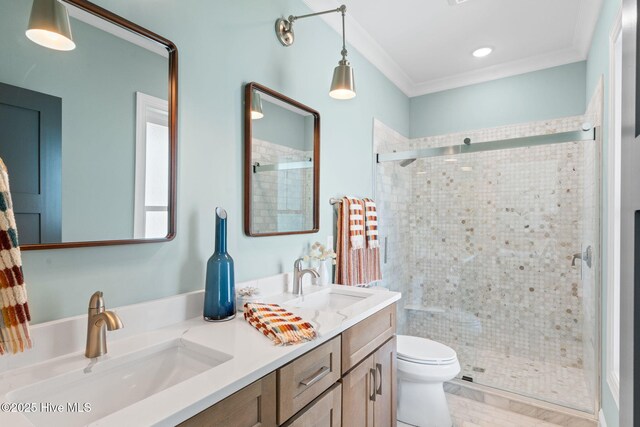 412 Keziah St, Oak Island, NC 28465 - bathroom featuring double vanity, toilet, a stall shower, and ornamental molding