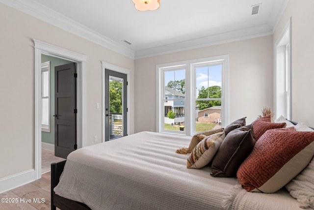 412 Keziah St, Oak Island, NC 28465 - bedroom featuring light wood finished floors, crown molding, baseboards, and access to outside