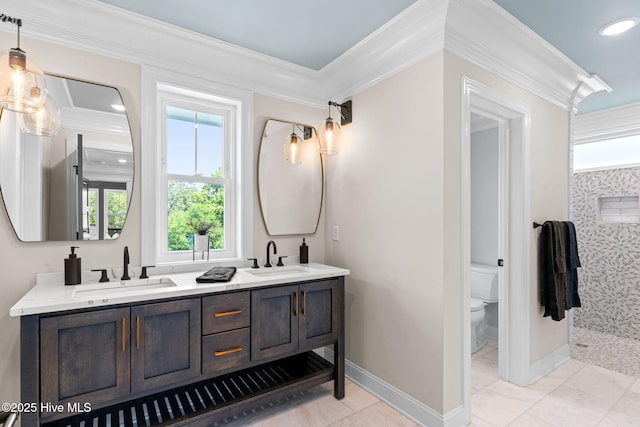 412 Keziah St, Oak Island, NC 28465 - bathroom with ornamental molding, double vanity, toilet, baseboards, and recessed lighting