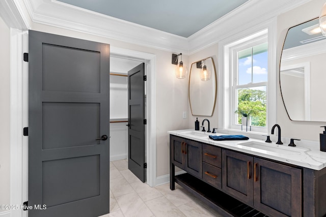 412 Keziah St, Oak Island, NC 28465 - bathroom featuring double vanity, crown molding, plenty of natural light, marble finish floors, and baseboards