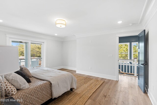 412 Keziah St, Oak Island, NC 28465 - bedroom with multiple windows, ornamental molding, access to exterior, baseboards, and light wood-style floors