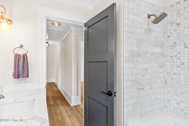 412 Keziah St, Oak Island, NC 28465 - bathroom with ornamental molding, wood finished floors, and a tile shower