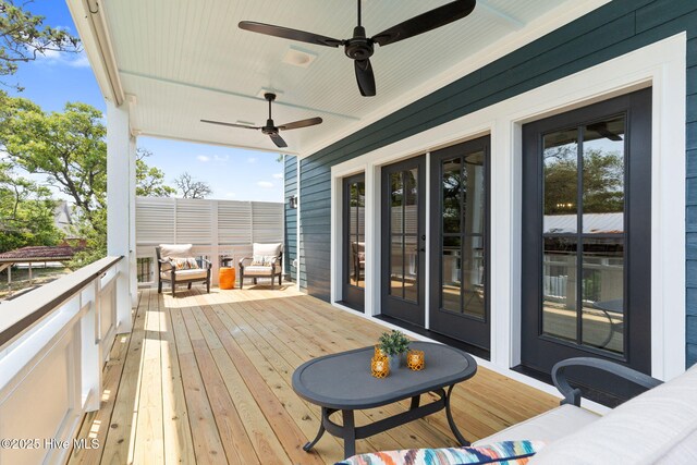 412 Keziah St, Oak Island, NC 28465 - wooden terrace with ceiling fan and outdoor lounge area