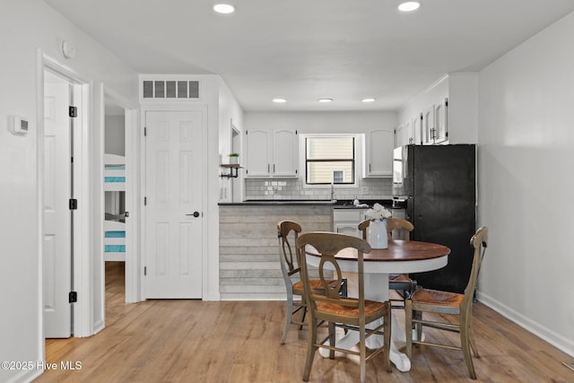 1503 Carolina Beach Ave N Unit 2A, Carolina Beach, NC 28428 - dining space featuring light wood-style flooring, recessed lighting, and baseboards
