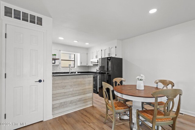 1503 Carolina Beach Ave N Unit 2A, Carolina Beach, NC 28428 - dining space with light wood-type flooring and recessed lighting