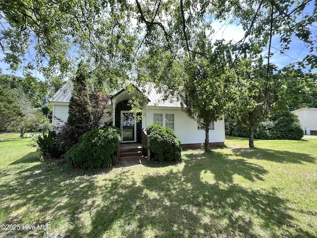 1412 Lyon Landing Rd, Elizabethtown, NC 28337 - view of property hidden behind natural elements featuring a front lawn and metal roof