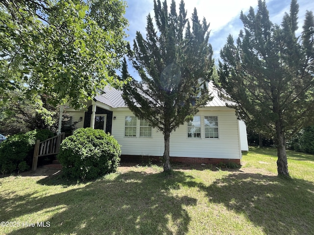 1412 Lyon Landing Rd, Elizabethtown, NC 28337 - view of property exterior featuring crawl space, a yard, and metal roof