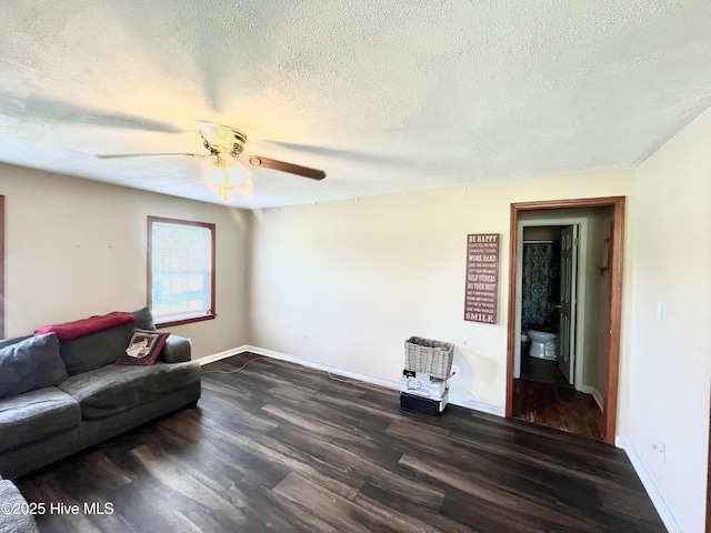1412 Lyon Landing Rd, Elizabethtown, NC 28337 - living room with dark wood-style floors, a textured ceiling, a ceiling fan, and baseboards