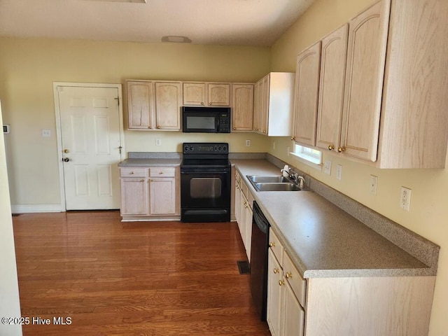 5702 Whichard Rd, Stokes, NC 27884 - kitchen with black appliances, a sink, light brown cabinets, dark wood finished floors, and light countertops