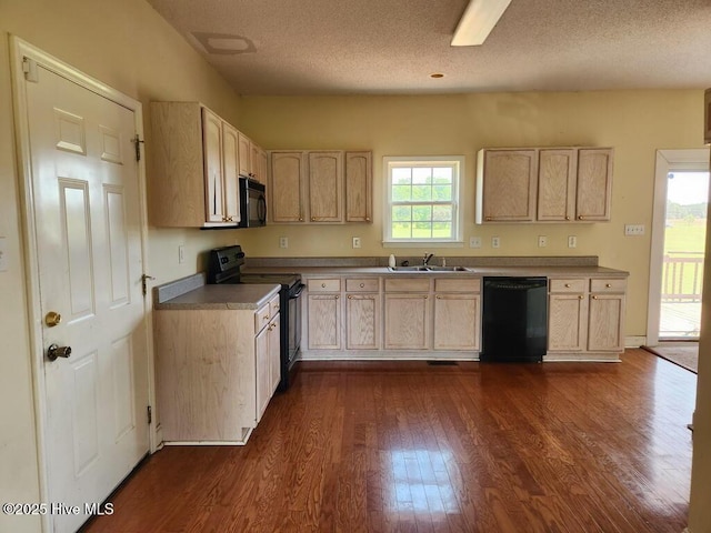 5702 Whichard Rd, Stokes, NC 27884 - kitchen featuring black appliances, a sink, dark wood-style flooring, light brown cabinetry, and a textured ceiling