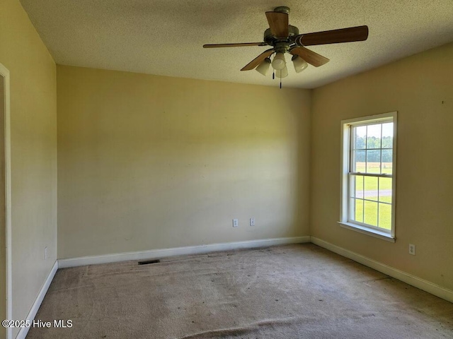 5702 Whichard Rd, Stokes, NC 27884 - carpeted spare room with a textured ceiling, baseboards, and a ceiling fan