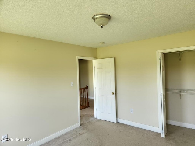 5702 Whichard Rd, Stokes, NC 27884 - unfurnished bedroom featuring a closet, carpet, baseboards, and a textured ceiling