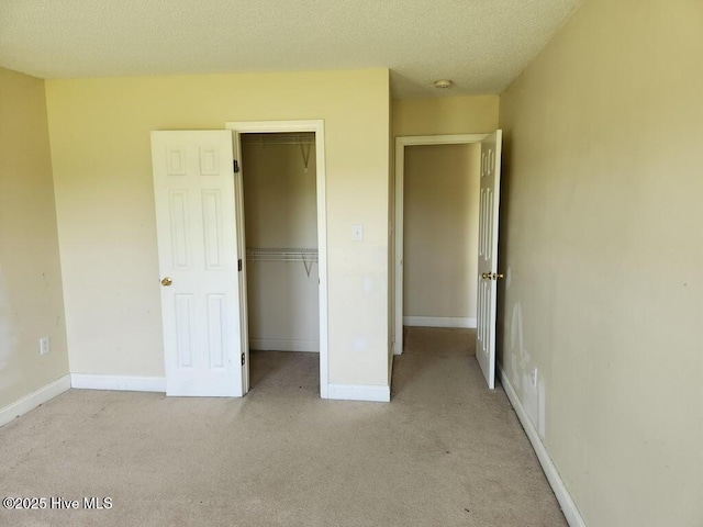 5702 Whichard Rd, Stokes, NC 27884 - unfurnished bedroom featuring carpet, a closet, baseboards, and a textured ceiling