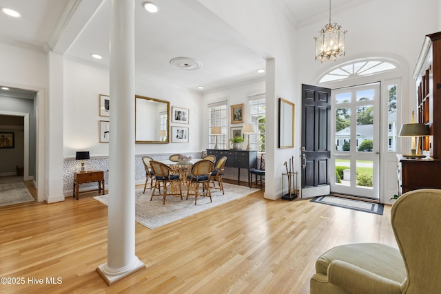 8300 Fazio Dr, Wilmington, NC 28411 - entrance foyer featuring ornamental molding, decorative columns, wood finished floors, recessed lighting, and a chandelier